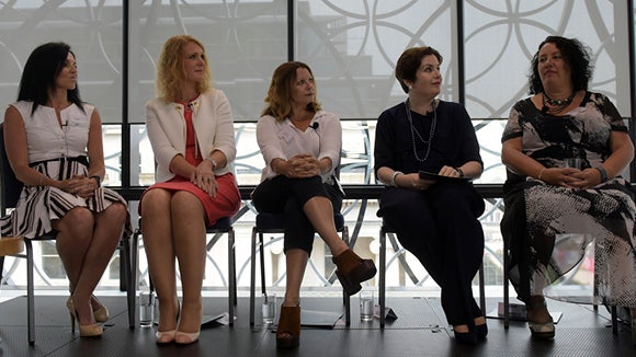panel of five women sitting on stage discussing employee retention techniques