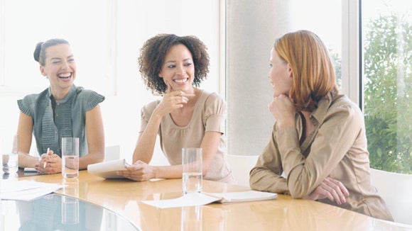 three women sitting around a table discussing diversity initiatives