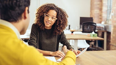 woman speaking with her boss about mentoring woman speaking with her boss about setting up a mentoring programme at her work