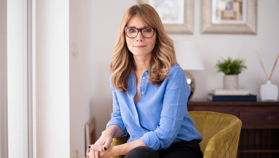 Portrait shot of beautiful woman relaxing in armchair while look