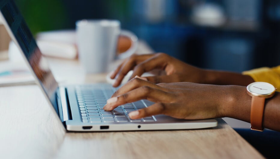 Woman typing on laptop